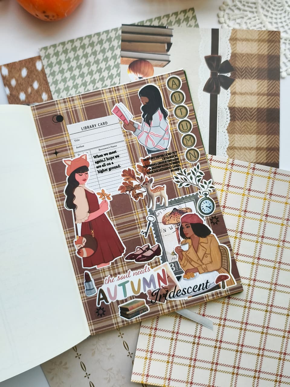 Autumn-themed planner spread created using Autumn Moments vinyl stickers layered over plaid scrapbook paper with cozy reading, coffee, books, and woodland-inspired embellishments.