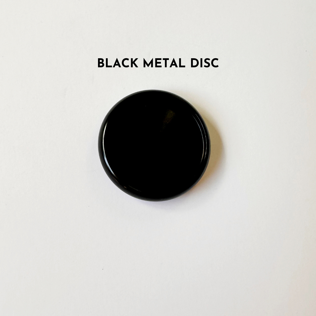 Black metal disc on white background