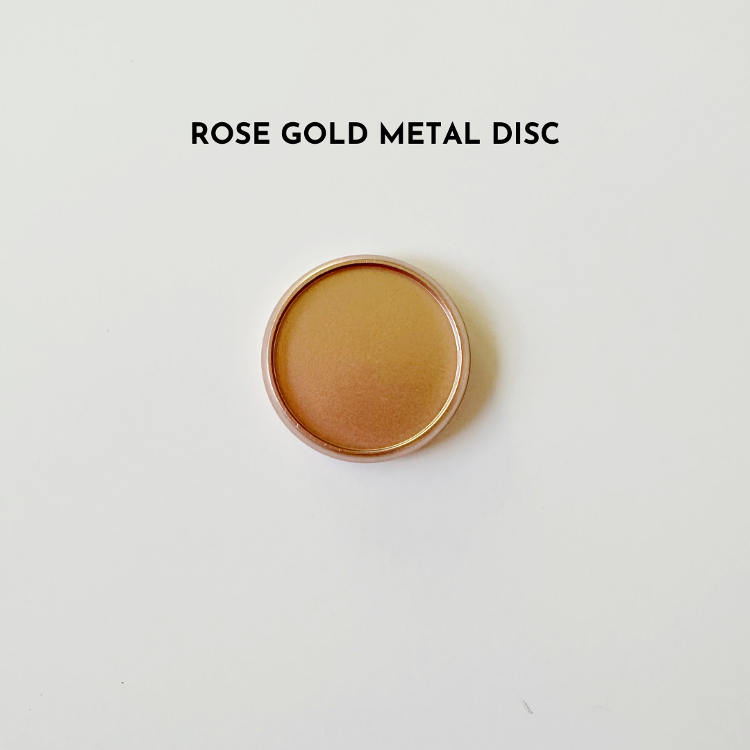 Rose gold metal disc on white background