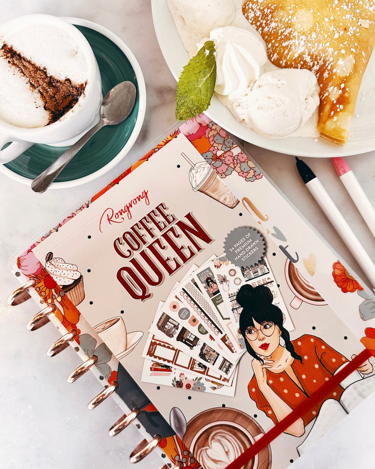 Coffee Queen sticker book flat lay with coffee and dessert