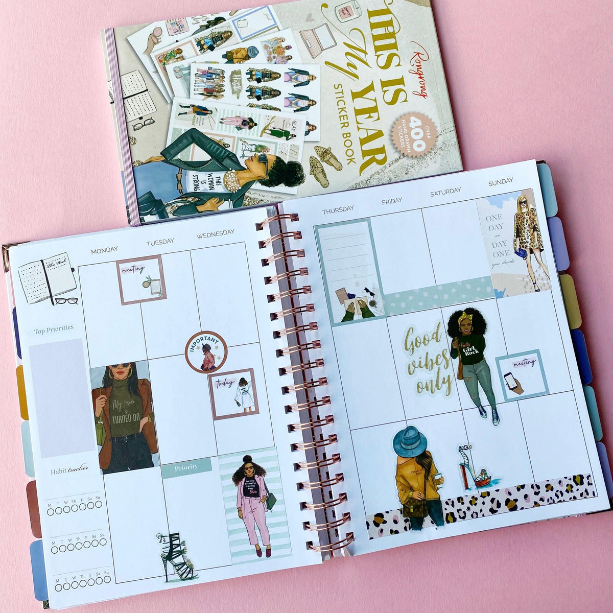 Planner with stickers on a pink background