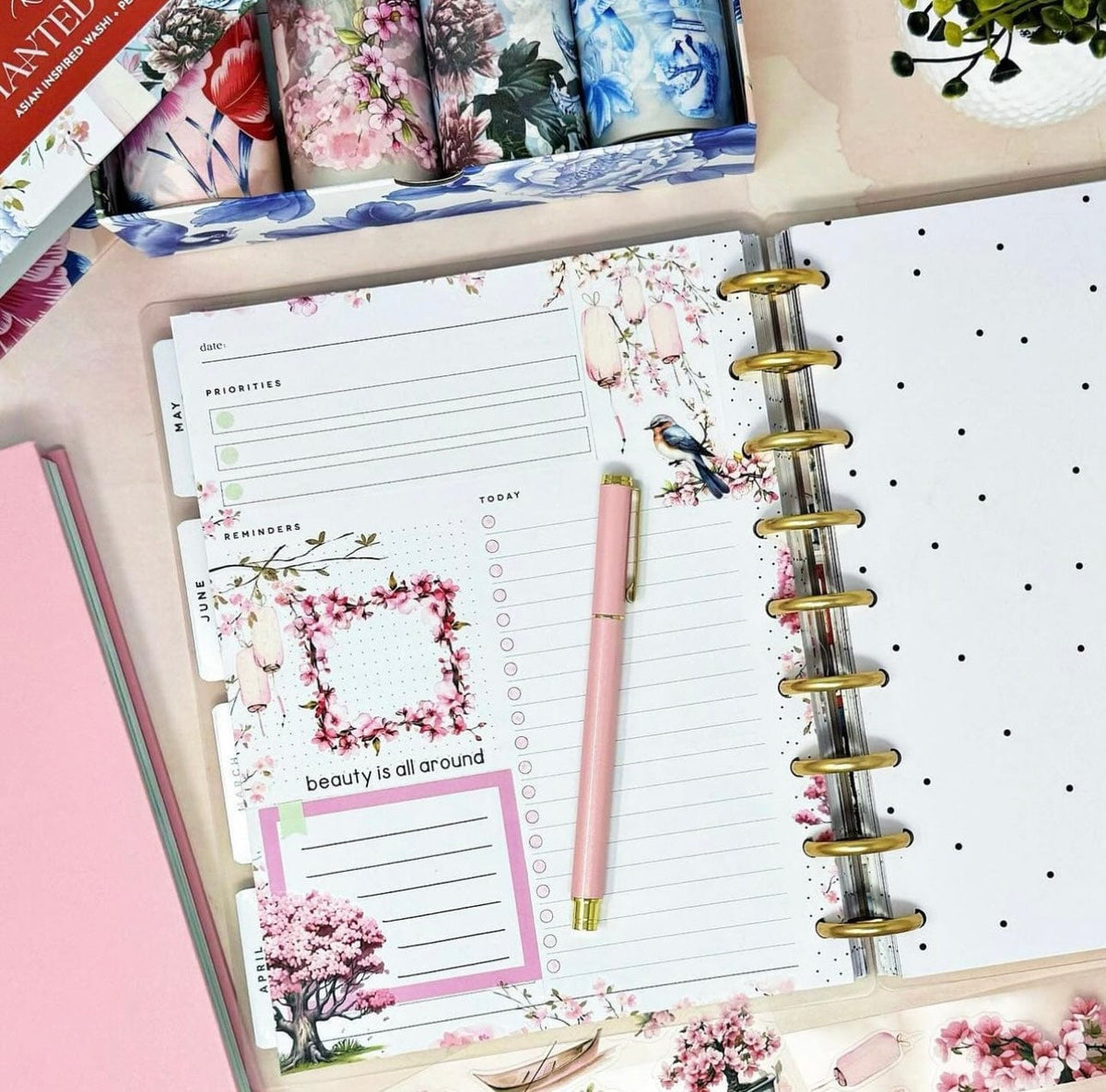 Floral planner flat lay with pen and Asian-inspired design