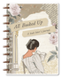 Journal cover with a woman reading a book, floral elements, and text &