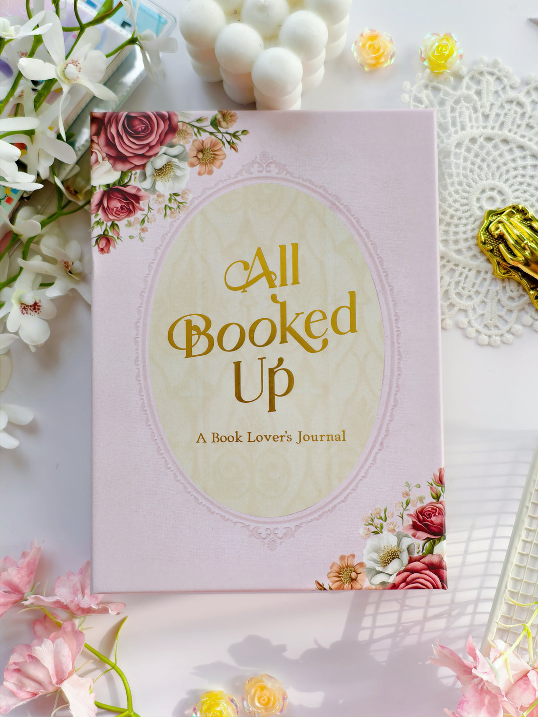 All Booked Up romantic reading journal cover with blush pink background, gold foil title, and floral design