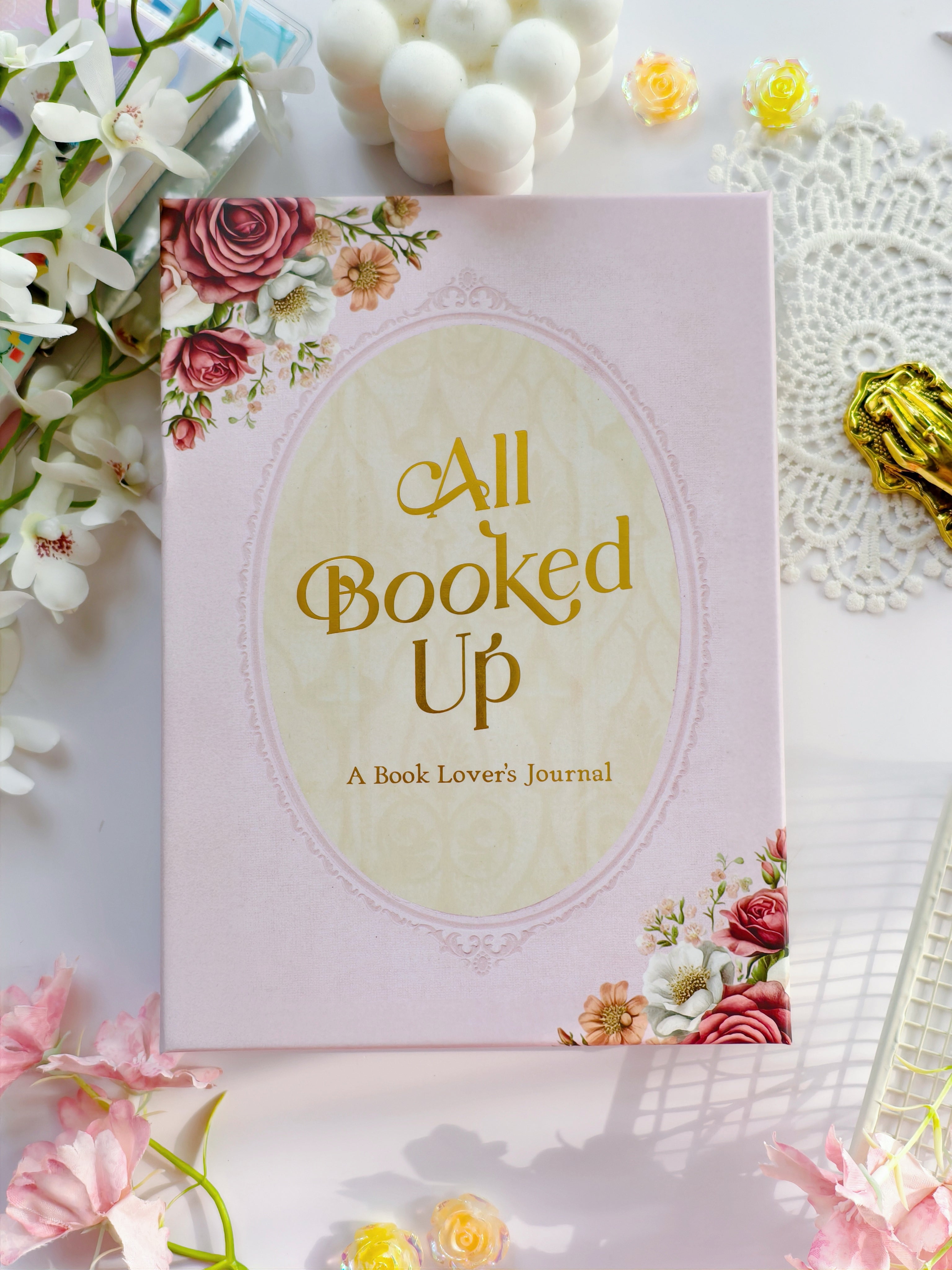 All Booked Up romantic reading journal cover with blush pink background, gold foil title, and floral design