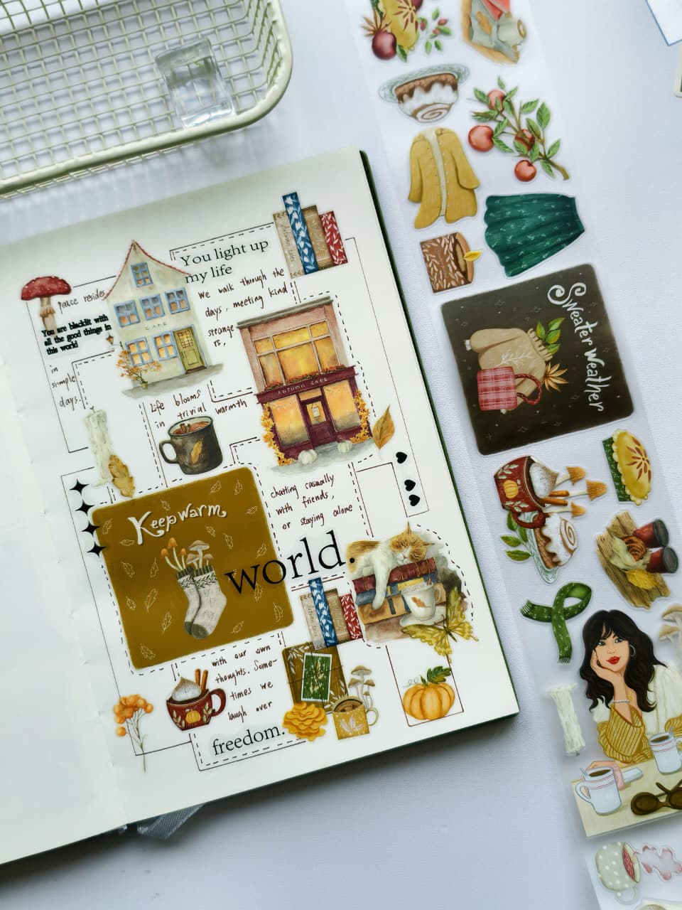 Journal spread decorated with Autumn Cafe Pre-cut PET Tape featuring cozy cafés, pumpkins, warm drinks, books, autumn leaves, cats, and seasonal illustrations in rich fall colors.