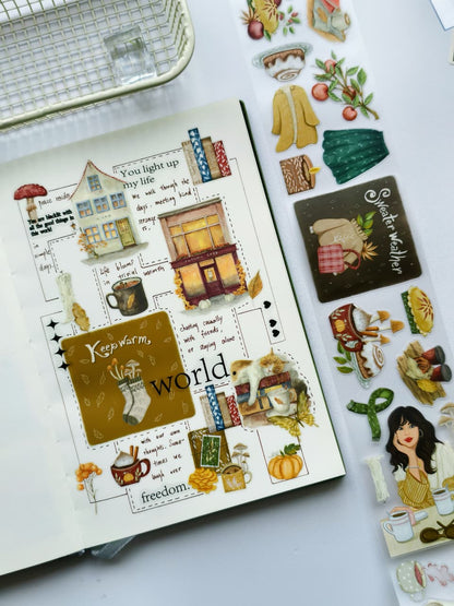 Journal spread decorated with Autumn Cafe Pre-cut PET Tape featuring cozy cafés, pumpkins, warm drinks, books, autumn leaves, cats, and seasonal illustrations in rich fall colors.