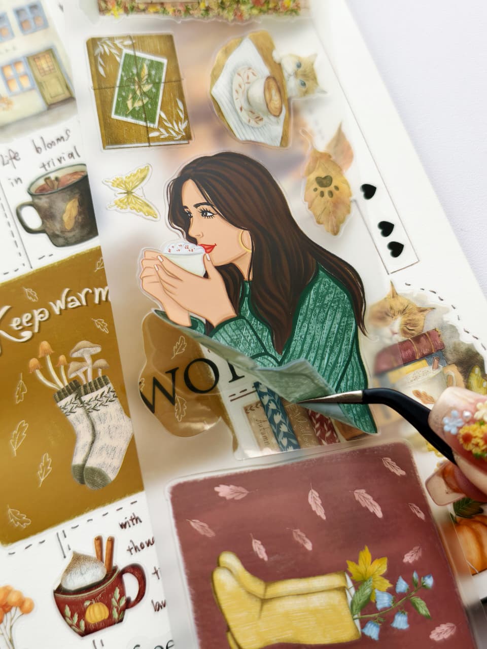 Close-up view of autumn-themed PET stickers featuring warm drinks, books, pumpkins, sleeping cats, cottage-style cafés, seasonal foliage, and cozy lifestyle illustrations.