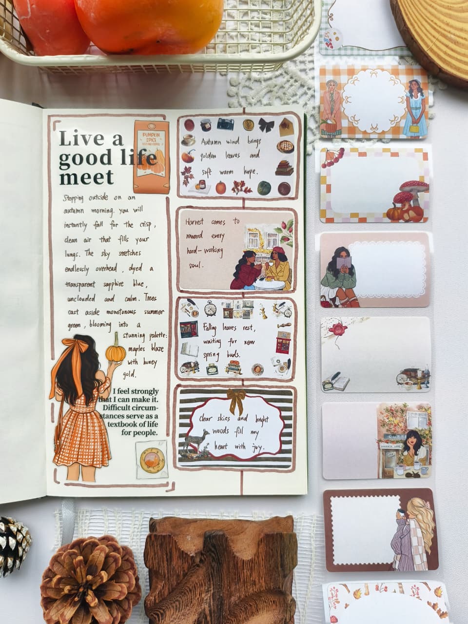 Open journal featuring a warm autumn-themed scrapbook spread paired with Autumn Memos Sticky Notes. The scene includes cozy illustrations, pumpkins, books, coffee, and decorative writable sticky notes in soft fall colors.