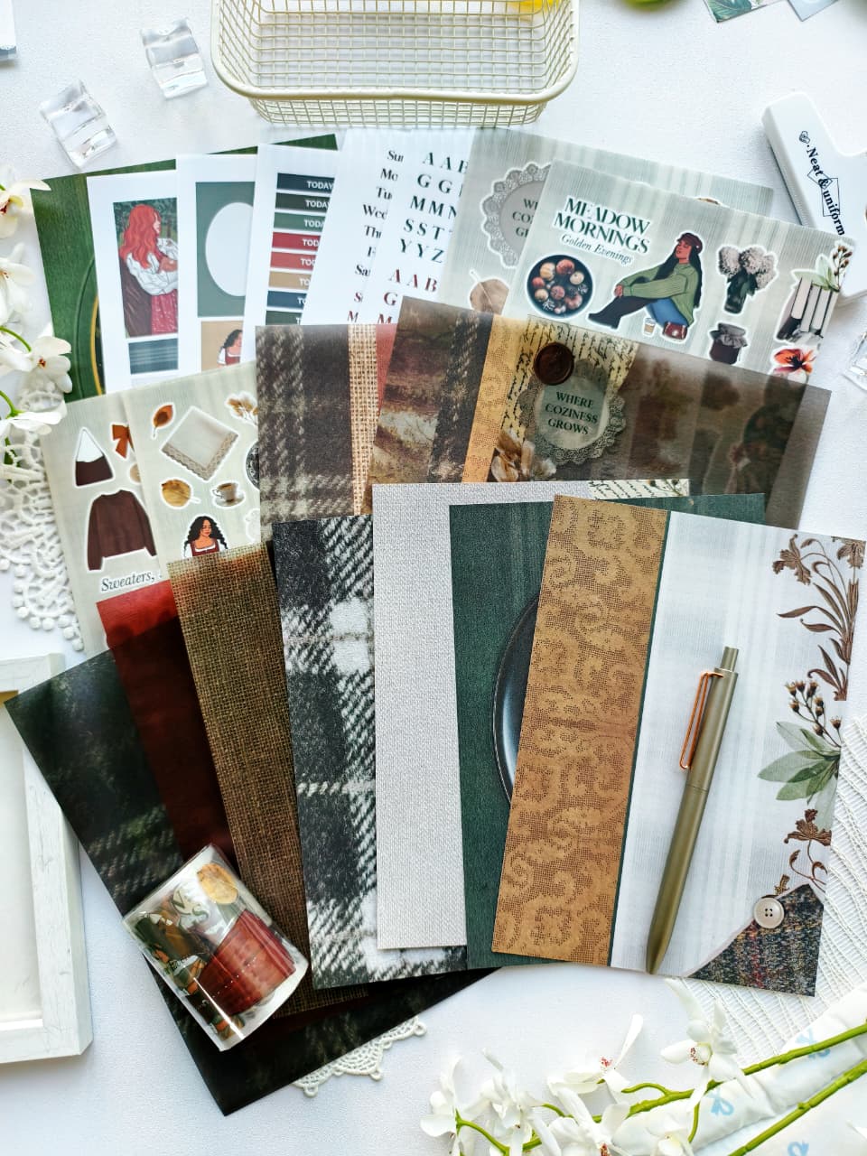 Flat lay of the Autumn Tales collection featuring PET tape, sticker sheets, journaling cards, decorative papers, alphabet stickers, and cozy autumn-inspired stationery in earthy neutral colors.