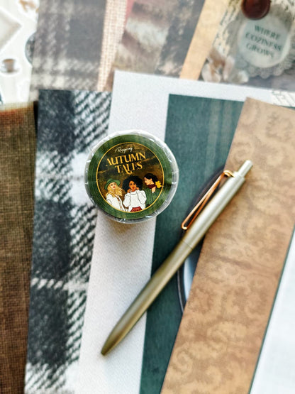 Autumn Tales PET tape roll displayed with layered autumn-inspired textures, plaid fabrics, earthy green and beige tones, and a cozy stationery flat lay featuring a muted green pen.