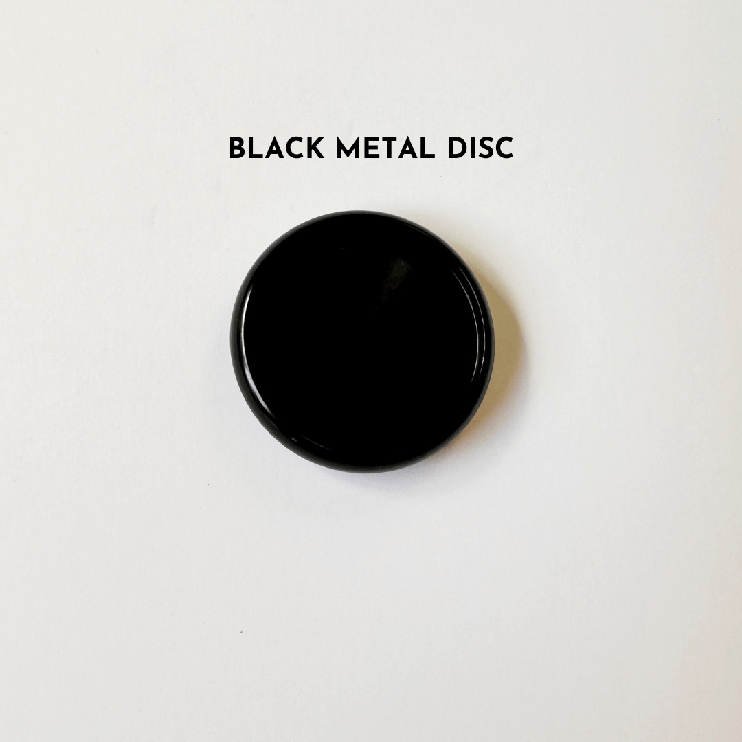 Black metal disc on white background