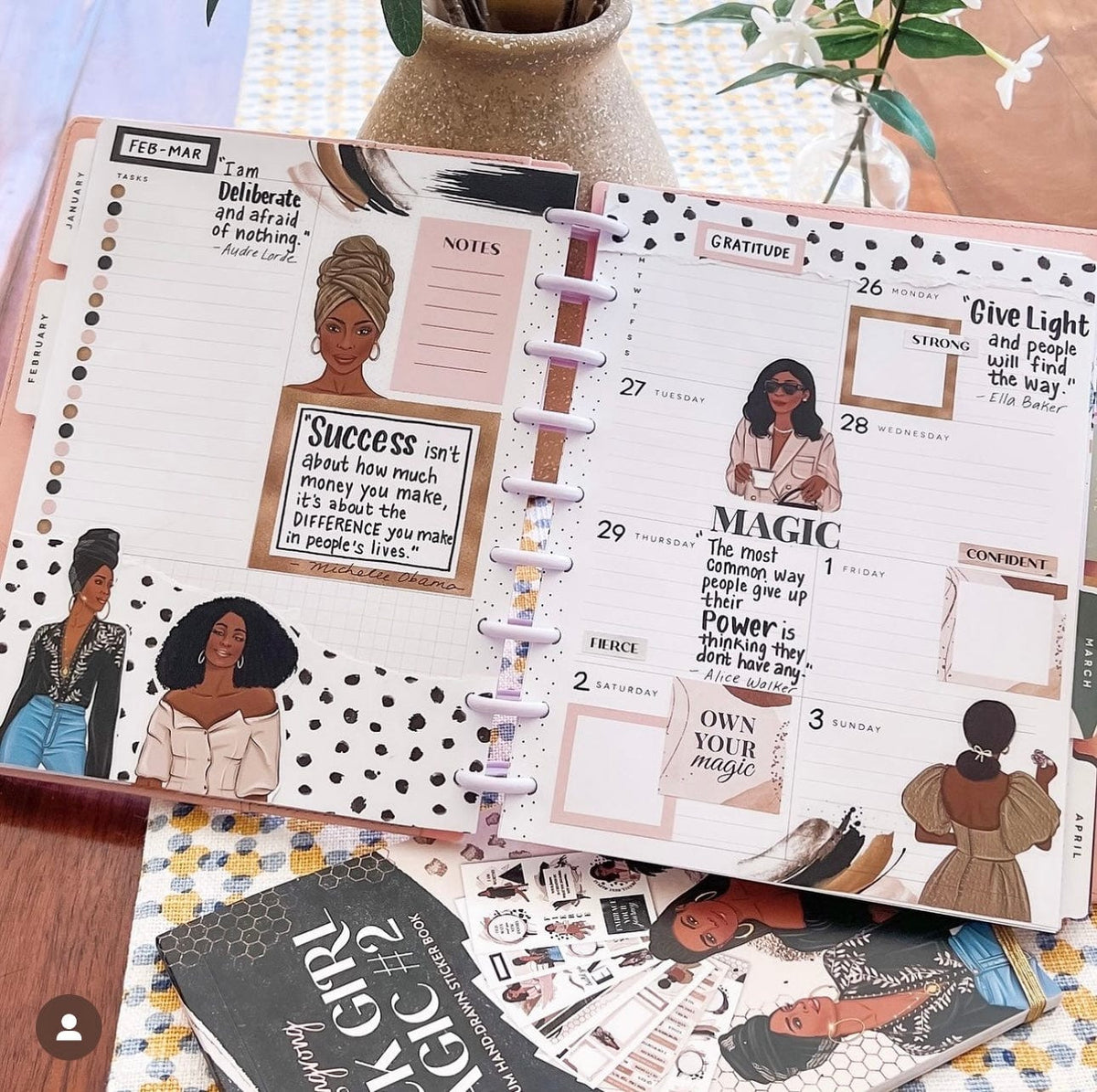 Planner with motivational quotes and images of a woman on a wooden surface.