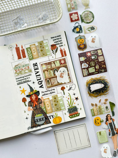 Creative journal page showcasing pre-cut PET stickers with cute ghosts, enchanted books, witchy décor, pumpkins, candles, stars, and cozy Halloween accents arranged in a scrapbook-style layout.