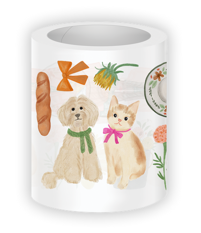 Close-up mockup of Cozy Cottage PET Tape featuring an adorable dog and cat with bows, cottagecore florals, bread, and cozy autumn aesthetic illustrations.