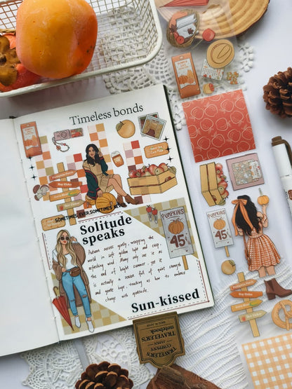 Angled view of a fall-themed journal spread decorated with Fall Festival PET Tape featuring pumpkin patch signs, apples, autumn fashion, seasonal ephemera, and cozy harvest-inspired illustrations.