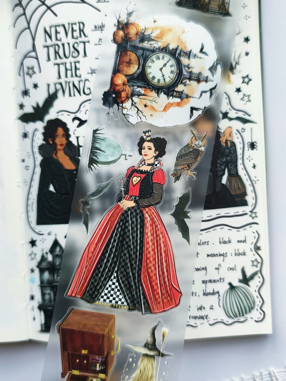 Close-up of Creepy Hollow pre-cut PET tape featuring a gothic queen illustration, haunted clock tower, pumpkins, owl, bats, witch hat, and vintage Halloween-inspired transparent planner stickers.