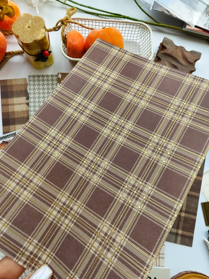 Hand holding a brown plaid scrapbooking paper with elegant gold foil detailing from the Dear Autumn collection, perfect for cozy fall journals, planners, scrapbooks, and paper crafts.