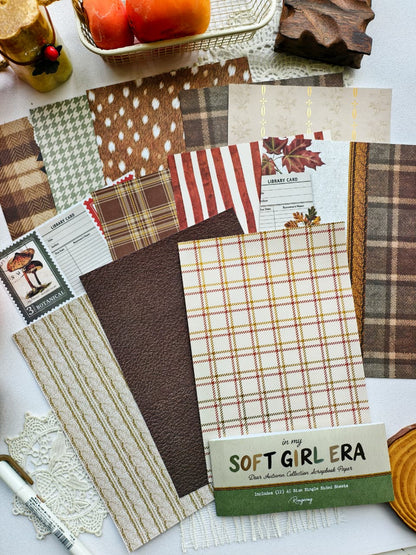 Flat lay of the Dear Autumn Scrapbooking Paper collection featuring plaid patterns, knit textures, botanical prints, library card designs, autumn colors, and cozy seasonal backgrounds.