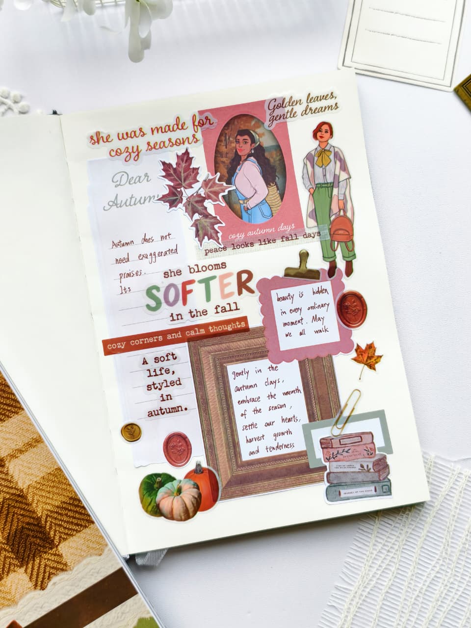 Cozy journal spread created with the Dear Autumn Sticker Book featuring autumn quotes, illustrated women, pumpkins, vintage frames, wax seals, colorful leaves, and soft fall-inspired embellishments in warm earthy tones.