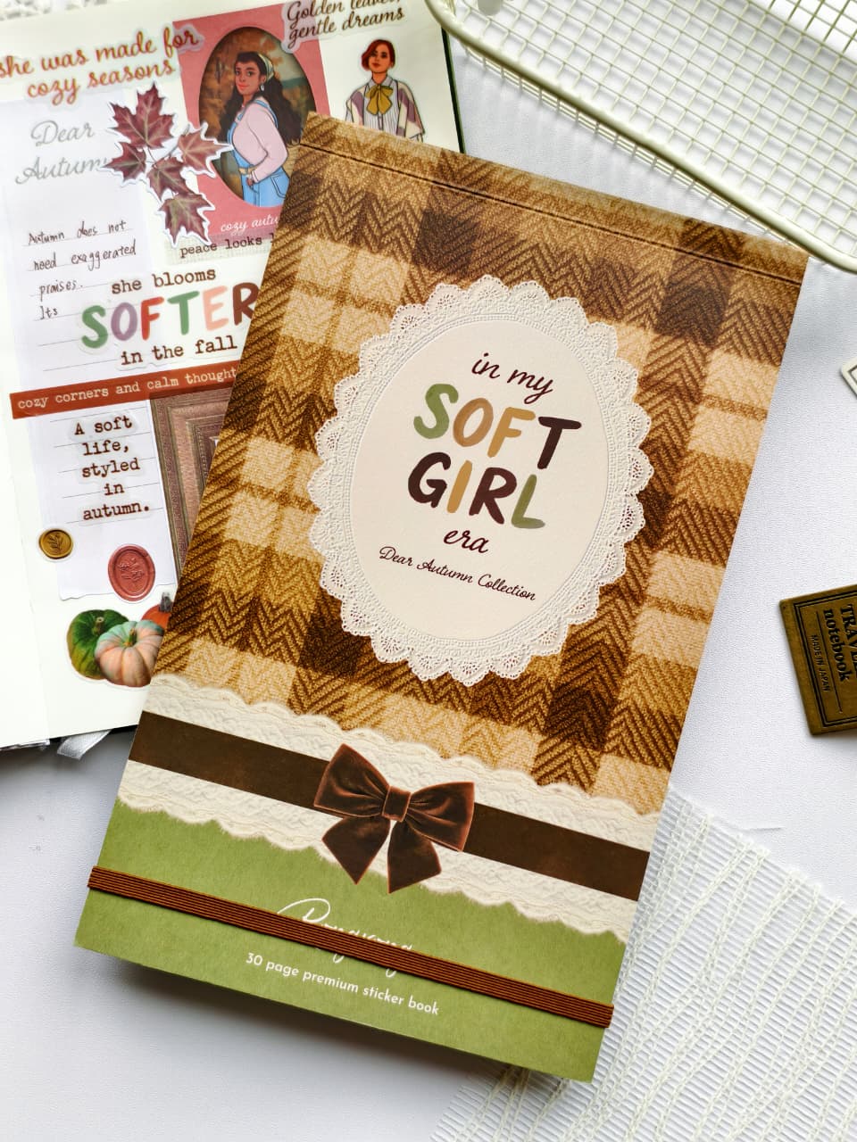 Styled product photo of the Dear Autumn Sticker Book placed beside a completed autumn journal spread, highlighting the cozy fall aesthetic and premium sticker collection.