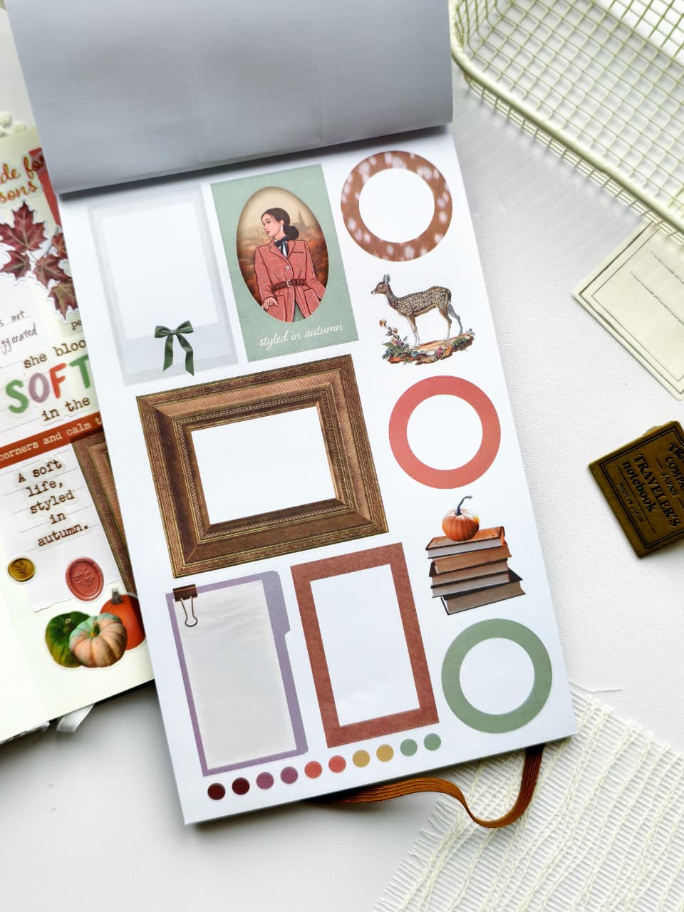 Sticker sheet featuring elegant vintage frames, circular labels, books, pumpkins, deer, and decorative journaling elements in a soft autumn-inspired color palette.