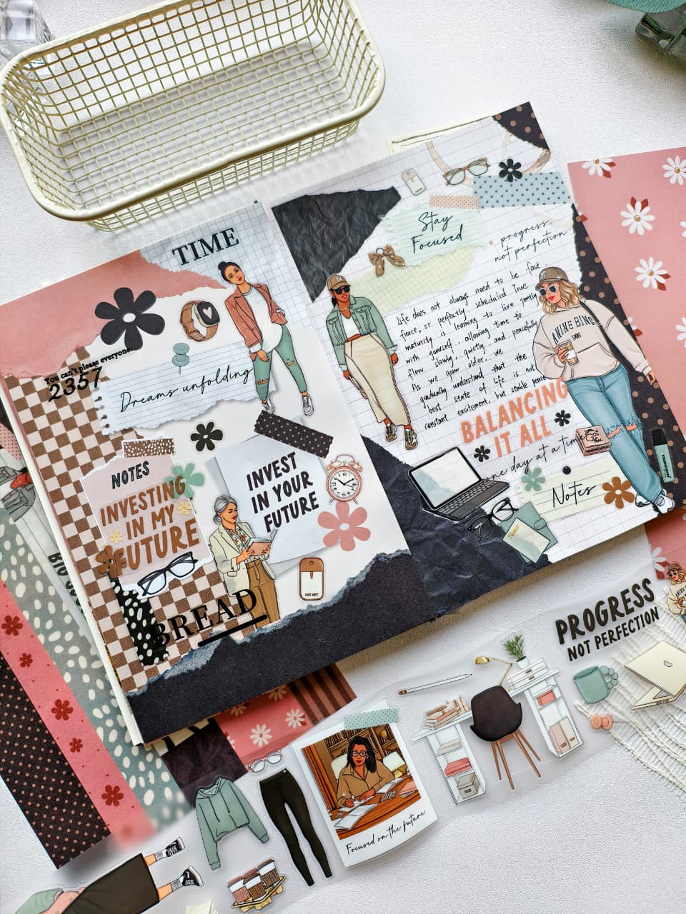 Close-up journal page featuring motivational stickers, professional women illustrations, watches, glasses, floral accents, and empowering messages about growth, goals, and investing in the future.