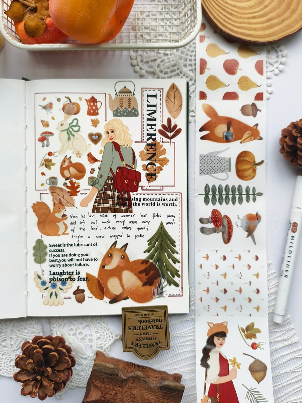 Open journal featuring a woodland-inspired autumn spread decorated with Foxberry Tales Washi Tape. The layout includes foxes, squirrels, rabbits, birds, mushrooms, pine trees, acorns, and a cozy autumn girl in warm earthy tones.