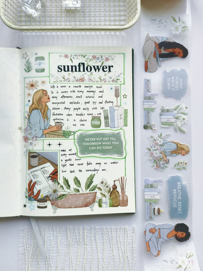 Flat lay of a journal decorated using Gentle Focus pre-cut PET tape with transparent self-care stickers, floral arrangements, books, wellness illustrations, and soothing green botanical accents.