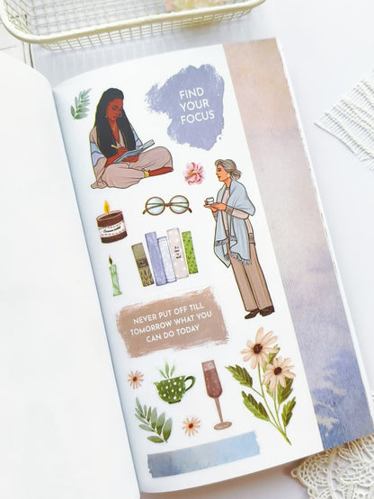 Sheet of stickers with illustrations and motivational phrases on a white surface.