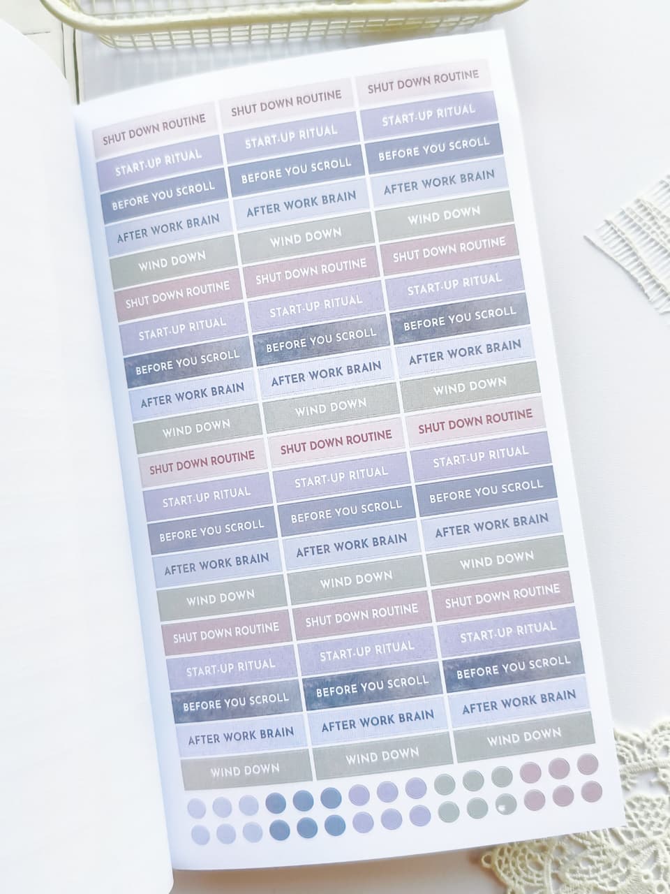 Sheet of planner stickers with routines and rituals on a white surface