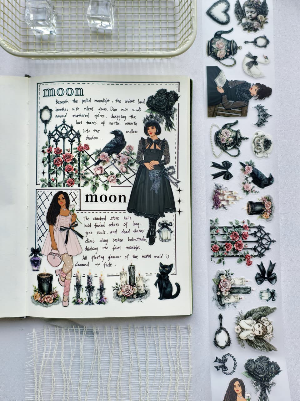 Flat lay of a planner decorated using Gothic Coquette pre-cut PET tape with elegant gothic fashion stickers, black cats, ravens, roses, candles, floral teapots, and Victorian-inspired accents.