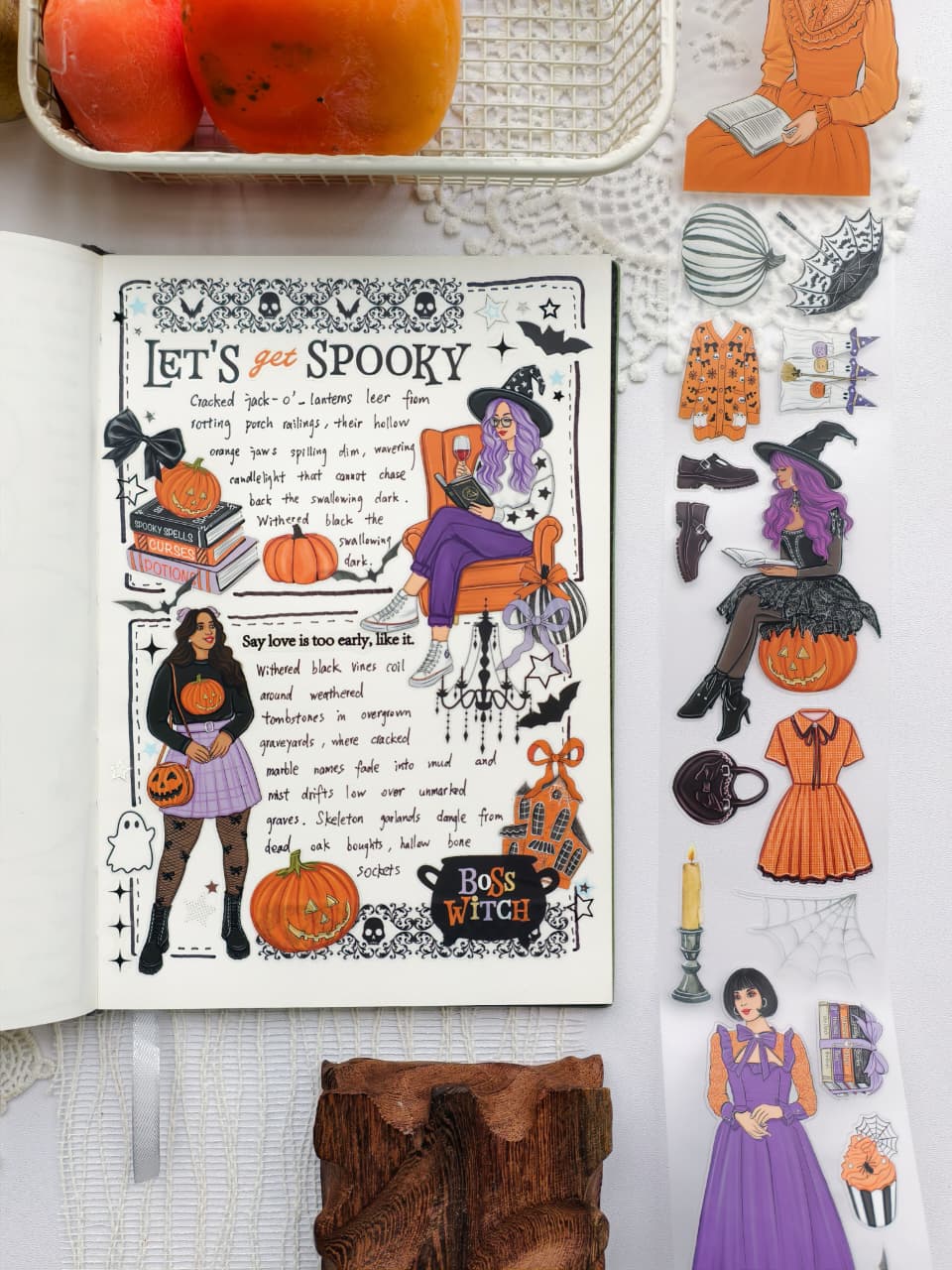 Open journal decorated with the Happy Haunts PET Tape featuring spooky Halloween illustrations, pumpkins, witches, bats, and cozy gothic accents alongside detailed decorative stickers.