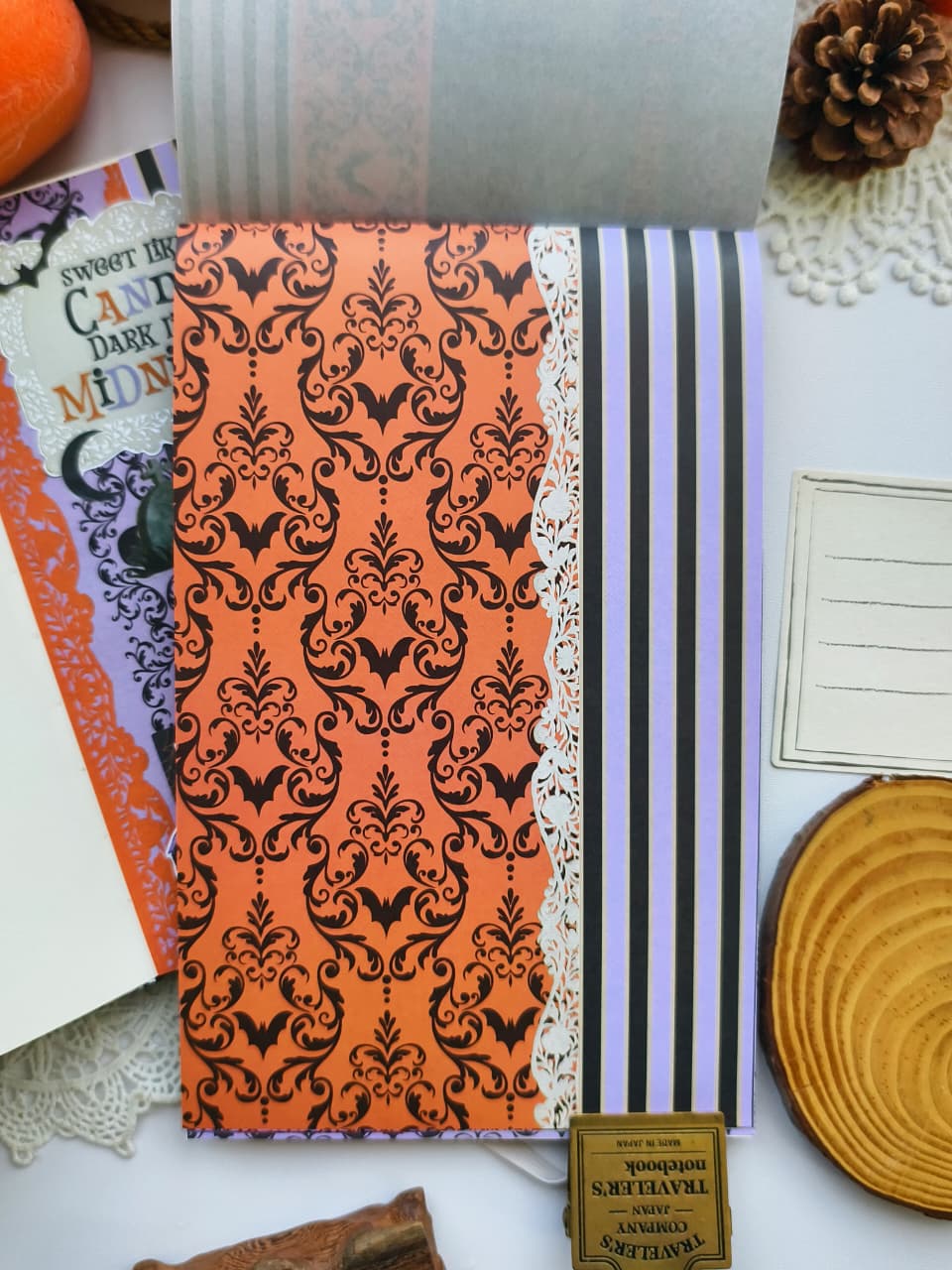 Halloween scrapbook paper page inside the Happy Haunts Sticker Book featuring gothic damask, striped, lace, and spooky patterned backgrounds for layering journal spreads.