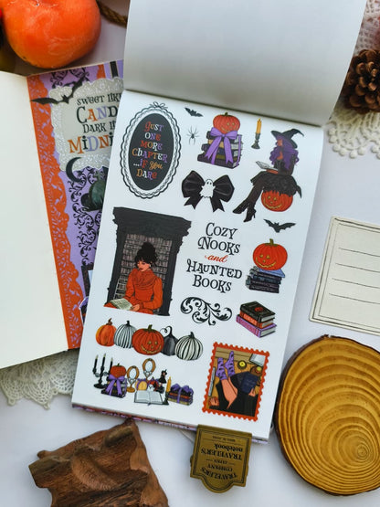 Open Happy Haunts Sticker Book displaying decorative Halloween stickers with cozy reading scenes, pumpkins, witch illustrations, bats, books, and gothic-inspired accents for journals and planners.