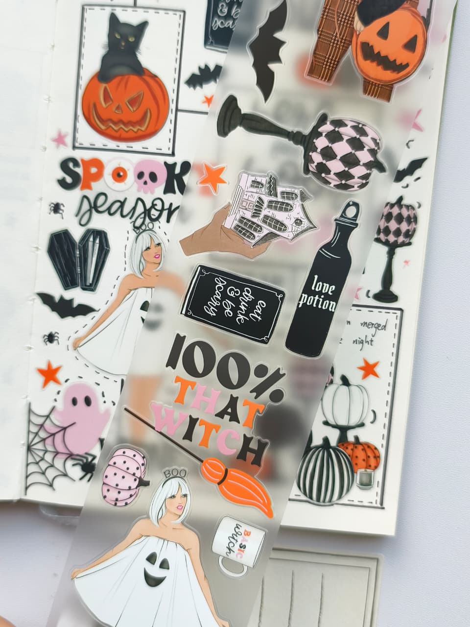 Detailed PET tape designs showcasing cute ghosts, potion bottles, spooky signs, bats, pumpkins, Halloween typography, and whimsical costume-inspired illustrations on transparent PET material.