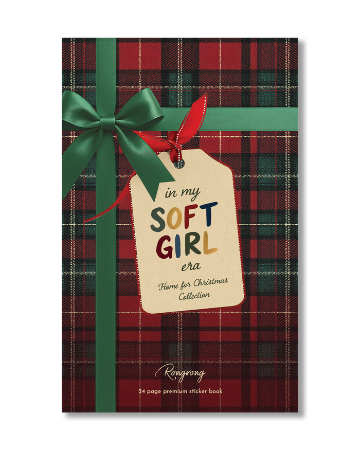 A rectangular book or booklet cover featuring a red and green plaid pattern, wrapped with a green ribbon and bow and a hanging cream tag that reads 'in my SOFT GIRL era Home for Christmas Collection.' Visible brand text at the bottom reads 'Renyong' with '24 page premium sticker book' underneath.