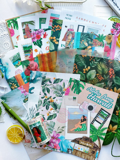 Flat lay of the Island Daydreams Monthly Planning Kit accessories featuring decorative papers, vellum, tropical journaling cards, island-inspired stickers, floral ephemera, and Hawaiian-themed stationery supplies.