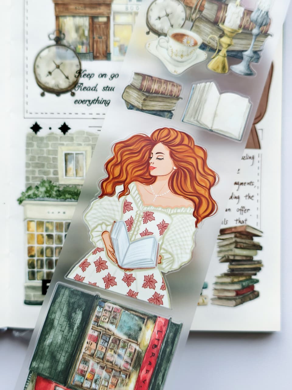 Detailed view of Magic Library PET tape showcasing a red-haired reader, open books, antique candles, vintage bookstore window, and whimsical literary illustrations on transparent PET material.