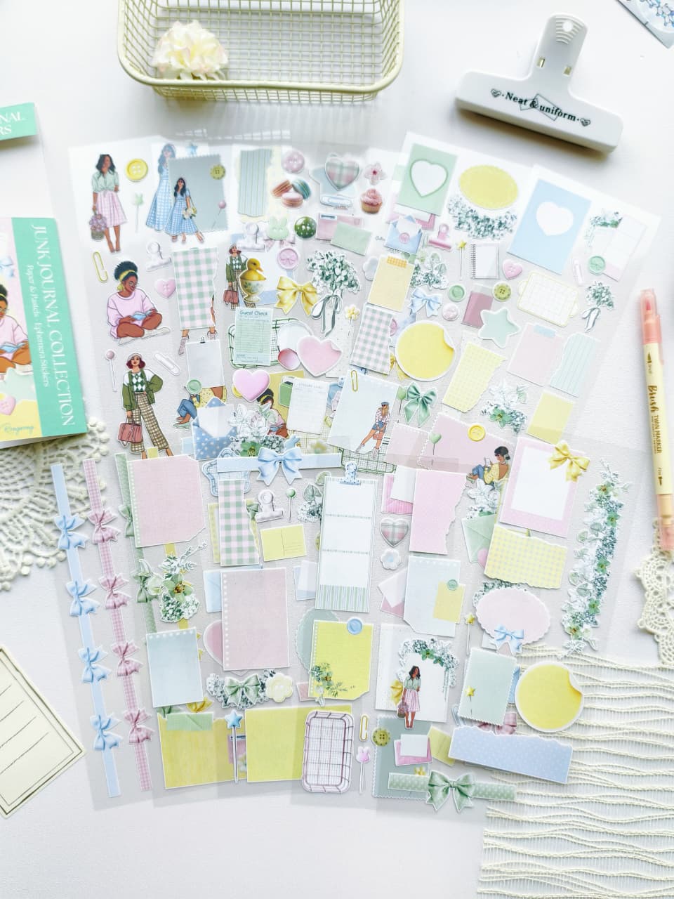 Full set of pastel ephemera stickers featuring bows, florals, pastel memo papers, envelopes, hearts, and illustrated girls arranged on a white desk.