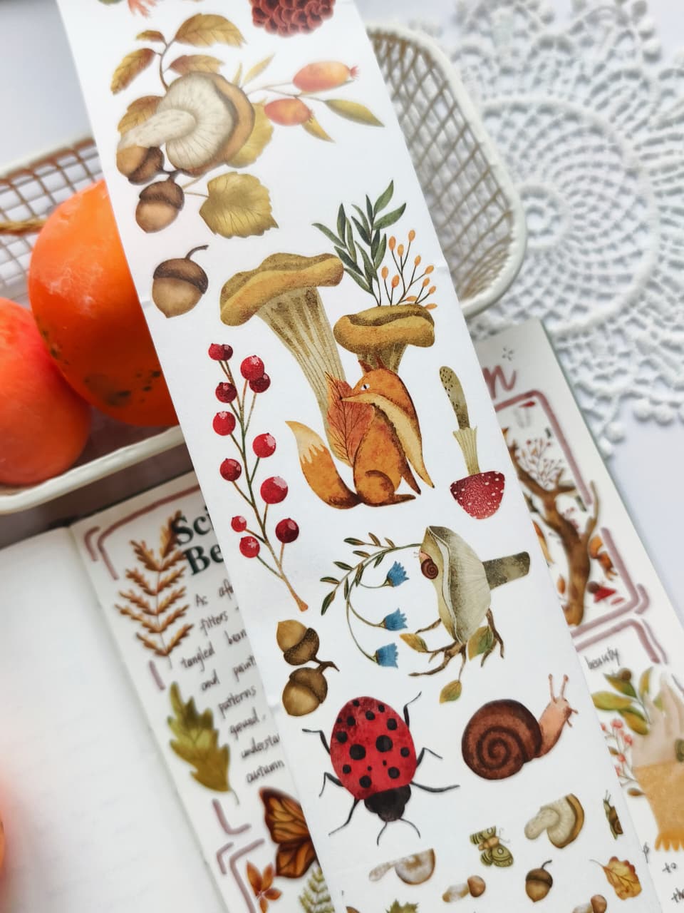 Close-up of Sweet Fall Washi Tape featuring watercolor mushrooms, fox, berries, acorns, ladybug, snail, woodland plants, and delicate forest-inspired botanical illustrations.