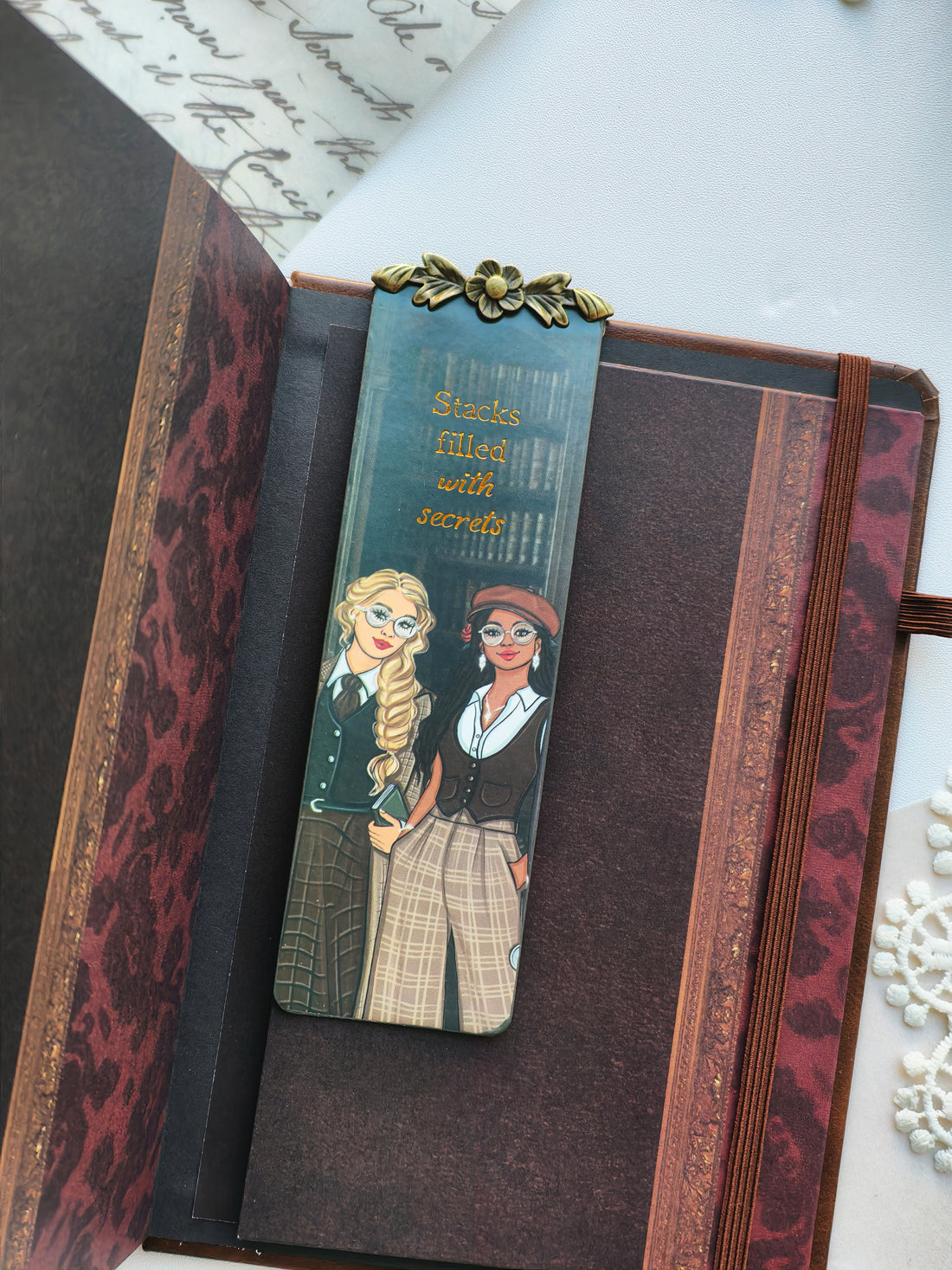 A decorative bookmark featuring an illustrated girl and gold text that reads &