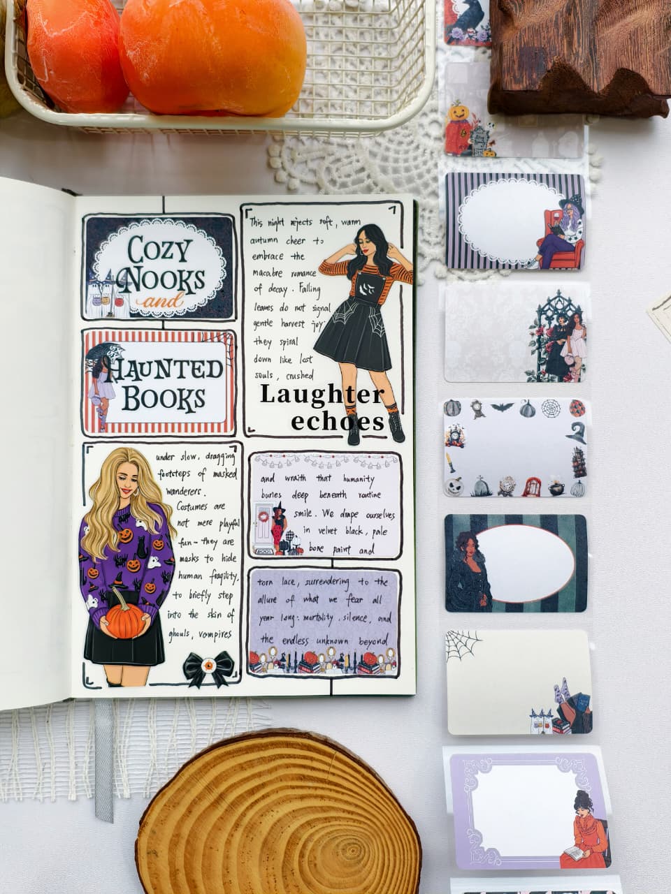 Open journal featuring a cozy Halloween-themed scrapbook spread with decorative stickers and journaling, displayed beside a collection of Wicked Little Notes sticky notes with gothic-inspired illustrations and writable labels.