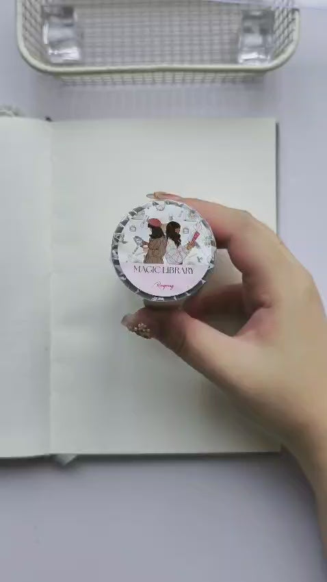 Video demonstrating the use of Magic Library Pre-cut PET Tape in a book-themed journal spread, featuring pre-cut transparent stickers with bookstores, vintage books, readers, antique clocks, cozy library decor, and literary-inspired embellishments for creative journaling