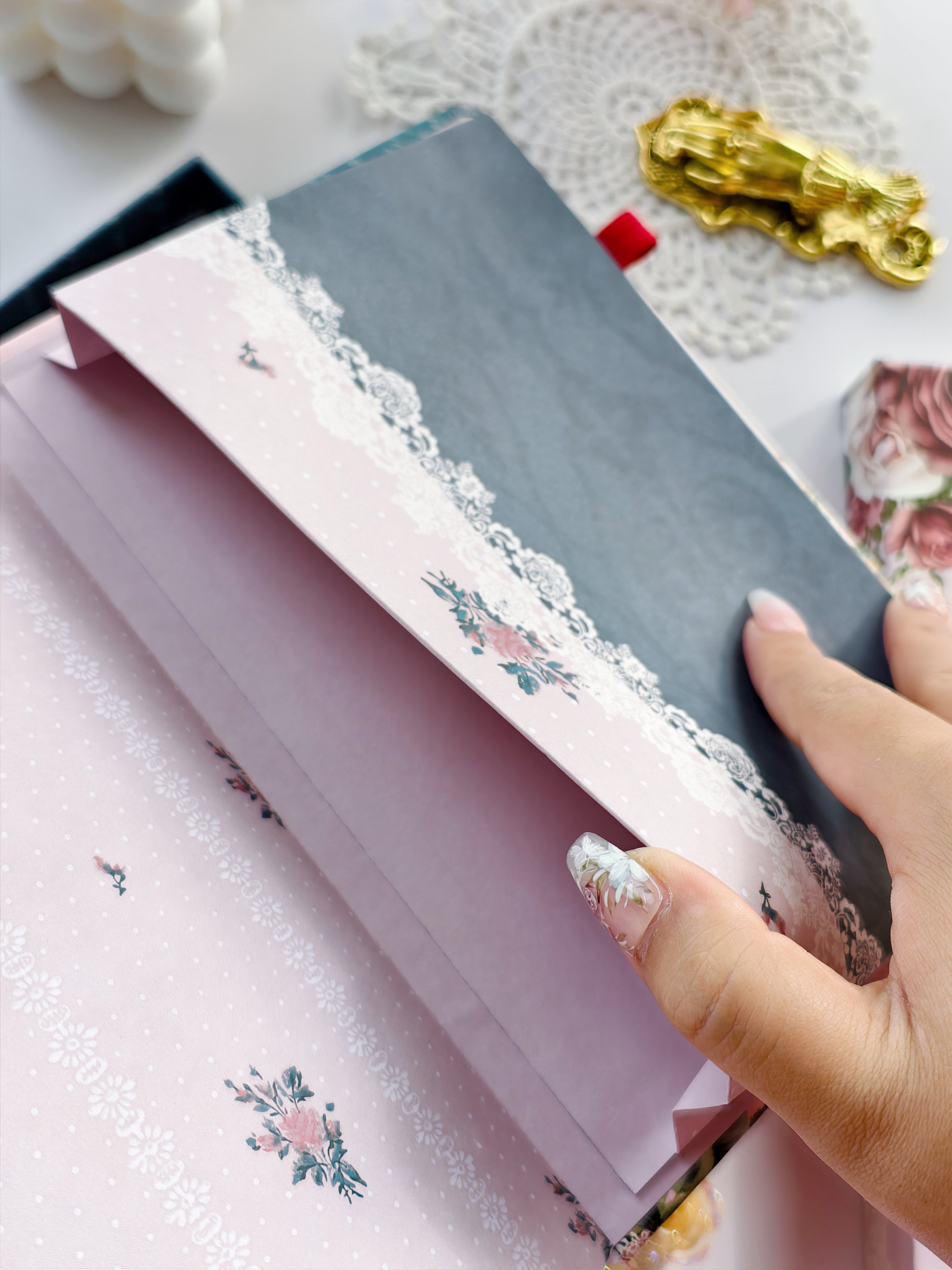 Decorative lace-style pocket envelope inside reading journal for storing notes, stickers, or keepsakes