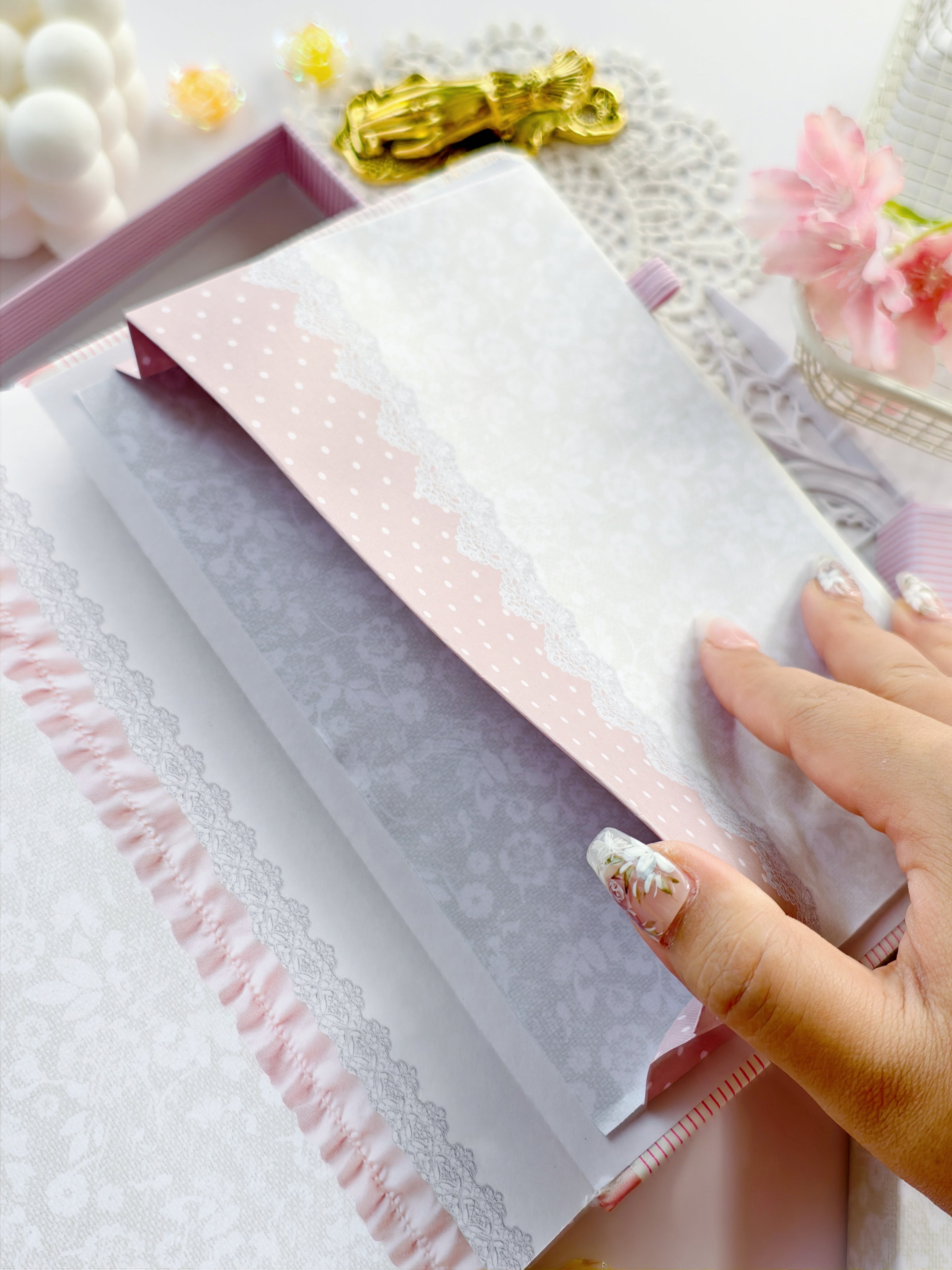 Back cover of Soft Girl Era journal featuring lace textures, satin ribbon, and soft pink striped design